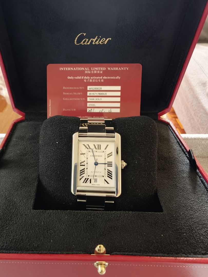Cartier Tank solo Xl 2017 (Category: Luxury Watches) located in Quezon City. Submitted by rafmag2484 (Listing ID 1471022572, Image 3). Description: Cartier Tank Solo XL 2017 Original box and card Reference Number: W5200028 Movement: Automatic self-winding Case & Bracelet: Stainless steel with rectangular links Dial: white opaline dial with black Roman numerals, blued-steel sword-shaped hands, and a date window at the 6 o'clock position. Crown: Be