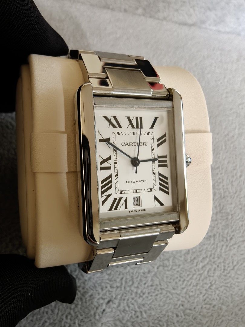 Cartier Tank solo Xl 2017 (Category: Luxury Watches) located in Quezon City. Submitted by rafmag2484 (Listing ID 1471022572, Image 1). Description: Cartier Tank Solo XL 2017 Original box and card Reference Number: W5200028 Movement: Automatic self-winding Case & Bracelet: Stainless steel with rectangular links Dial: white opaline dial with black Roman numerals, blued-steel sword-shaped hands, and a date window at the 6 o'clock position. Crown: Be