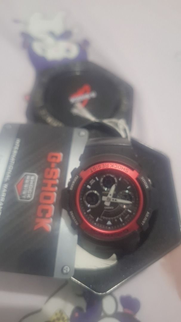 Casio G-Shock Black and Red Watch with Tin (Category: Women's Watches) located in Manila. Submitted by lor1878 (Listing ID 1471037368, Image 1). Description: - Authentic Casio G-Shock in sleek black with a bold red bezel ring - Dual analog and digital display layout for easy reading - Rugged, shock-resistant build with a comfortable, durable resin strap - Complete set includes the original hexagonal metal tin and international warranty card - Per