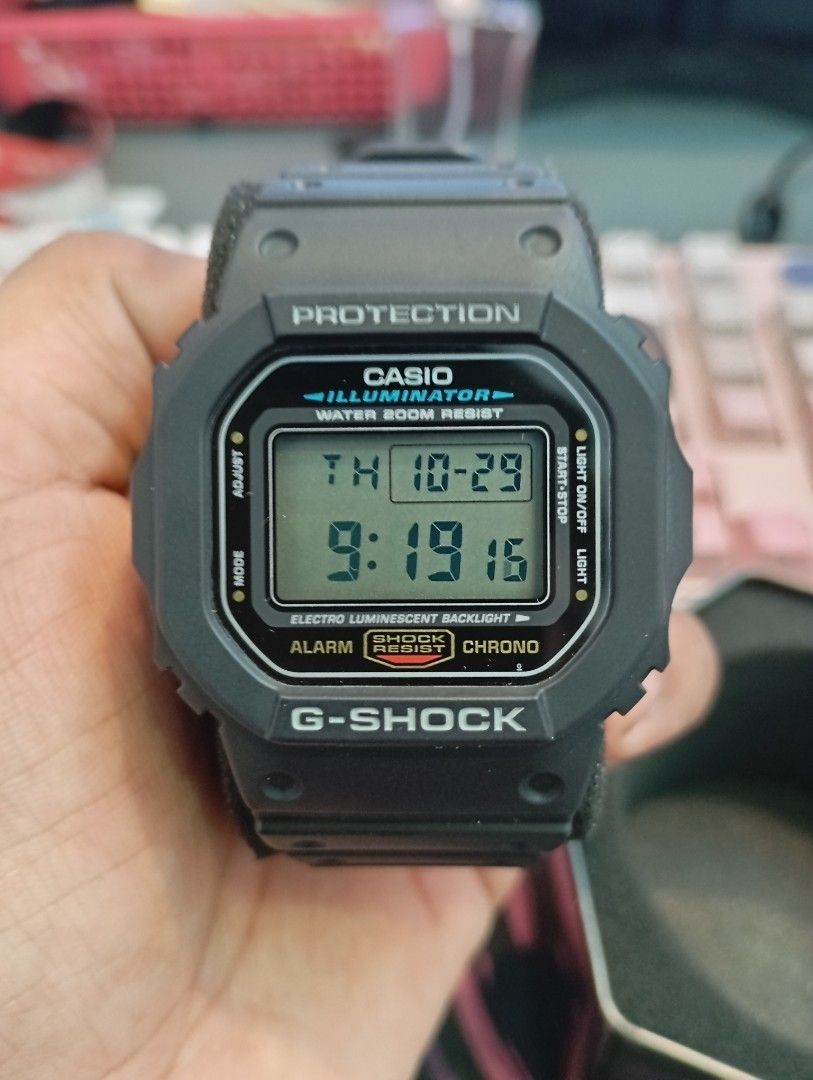 Casio G-Shock DW-5600E Digital Watch (Category: Men's Watches) located in Manila. Submitted by jcaseanti (Listing ID 1470941931, Image 2). Description: - Model: Casio G-Shock DW-5600E (Module 3229) - Condition: Clean, fully tested, and working properly - Design: Classic square digital watch with black resin strap and bezel - Key Features: Shock-absorbing structure, 200m water resistance, and electro-luminescent backlight - Inclusions: Original G-