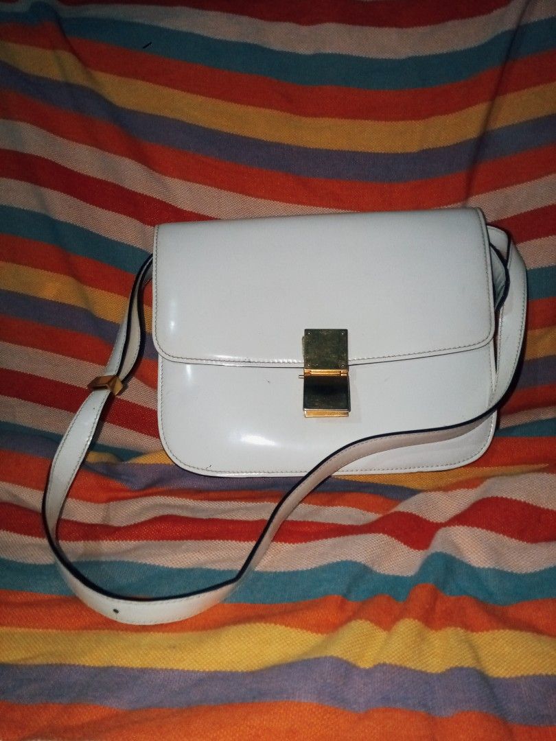 Celine Paris White Leather Shoulder Bag (Category: Luxury Bags & Wallets) located in Manila. Submitted by littlelove25 (Listing ID 1471096419, Image 1). Description: - Authentic Celine Paris white leather shoulder bag - Elegant gold-tone metal clasp closure with engraved branding - Adjustable shoulder strap for comfortable wear - Clean, structured classic flap silhouette - Interior features a handy zipper pocket and gold foil stamp logo under the