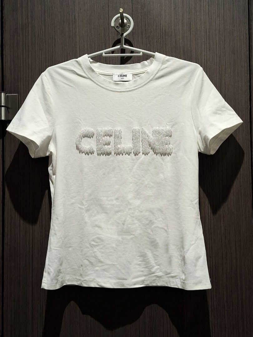 Celine SS21 Crystal Logo Shirt (Category: Shirts) located in Pasig City. Submitted by coveted.mnl (Listing ID 1471015417, Image 1). Description: In Pristine Condition📌 Best fit to: Medium Width : 17 Length : 24 (MEASURED BY INCHES) 9.5/10 overall condition No issues or flaws in fabric Retailed for $1,350 (P86,400) • P600 Slightly negotiable • Pasig City meet up • Open for COD Via Lalamove or Grab • J&T courier Message us for more info🤍 (measure