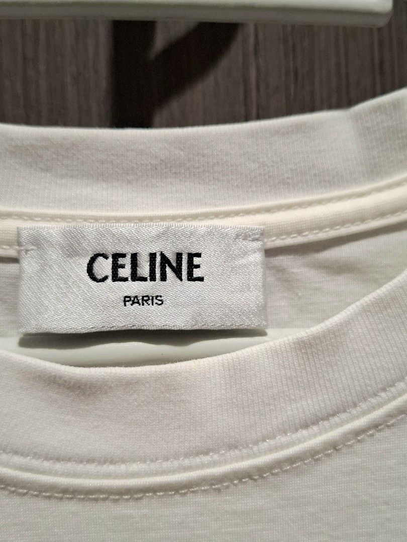 Celine SS21 Crystal Logo Shirt (Category: Shirts) located in Pasig City. Submitted by coveted.mnl (Listing ID 1471015417, Image 3). Description: In Pristine Condition📌 Best fit to: Medium Width : 17 Length : 24 (MEASURED BY INCHES) 9.5/10 overall condition No issues or flaws in fabric Retailed for $1,350 (P86,400) • P600 Slightly negotiable • Pasig City meet up • Open for COD Via Lalamove or Grab • J&T courier Message us for more info🤍 (measure