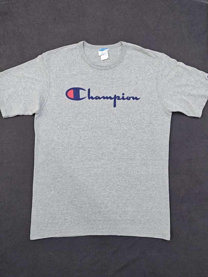 Champion Heather Grey Script Logo T-Shirt (Category: Tshirts & Polo Shirts ) located in Bulacan. Submitted by pzj_thrift (Listing ID 1470968163, Image 1). Description: condition 9/10 color rate 9/10 no issue.