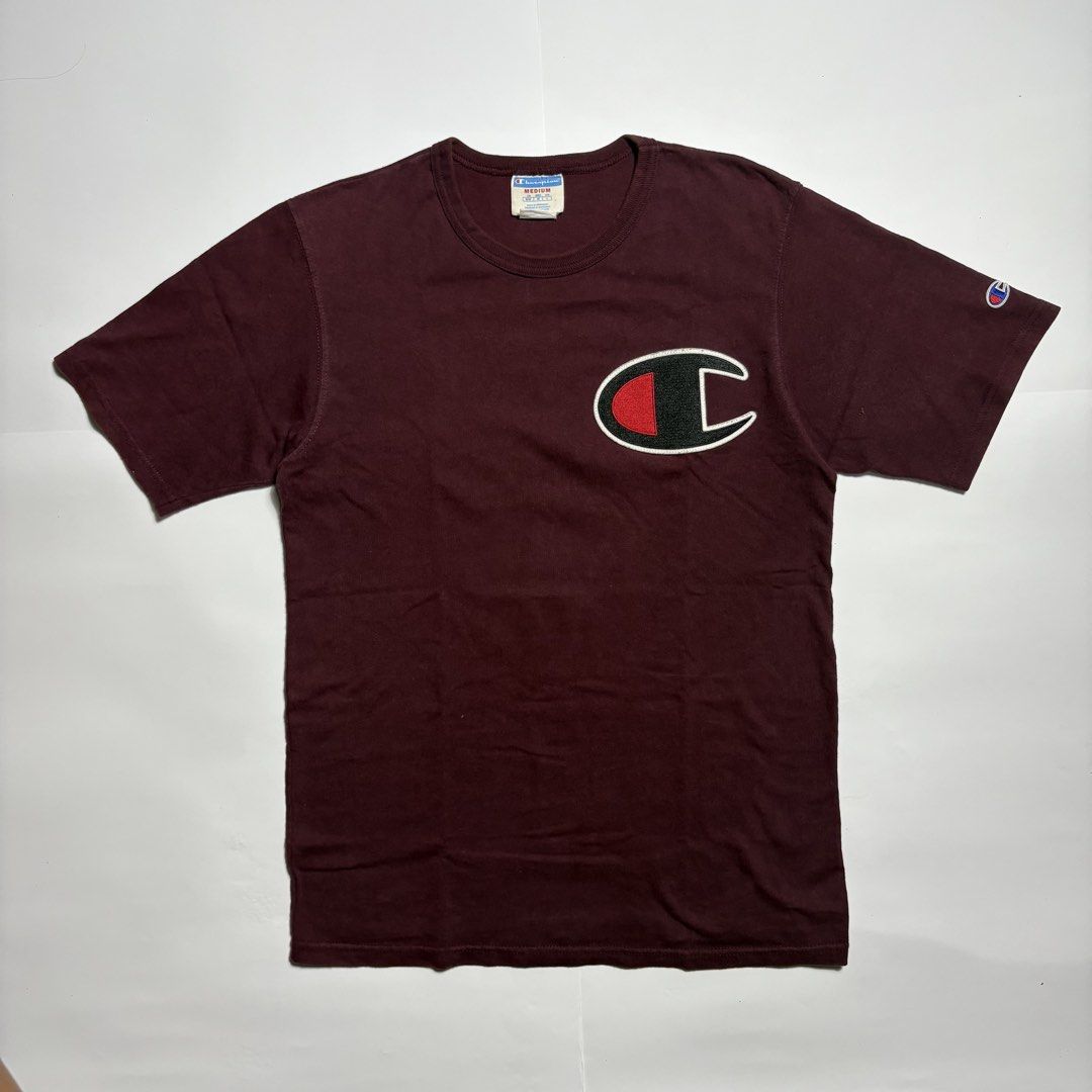 Champion Maroon Tee with Large Chest Patch Size M (Category: Tshirts & Polo Shirts ) located in San Fernando. Submitted by lumang_gamit (Listing ID 1471065357, Image 1). Description: - Color: Maroon - Brand: Champion - Size: Medium (Tag size) - Material: Comfortable cotton - Fit: Standard regular fit - Details: Large C patch logo on chest, small embroidered logo on left sleeve, crew neck, solid back - Origin: Made in Honduras.
