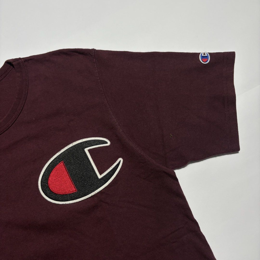 Champion Maroon Tee with Large Chest Patch Size M (Category: Tshirts & Polo Shirts ) located in San Fernando. Submitted by lumang_gamit (Listing ID 1471065357, Image 2). Description: - Color: Maroon - Brand: Champion - Size: Medium (Tag size) - Material: Comfortable cotton - Fit: Standard regular fit - Details: Large C patch logo on chest, small embroidered logo on left sleeve, crew neck, solid back - Origin: Made in Honduras.