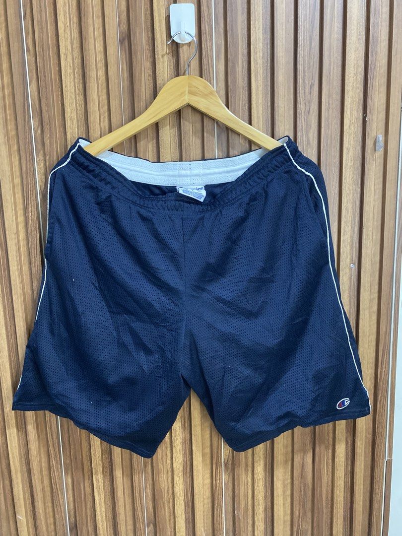 Champion Navy Blue Mesh Athletic Shorts (Category: Shorts) located in Caloocan City. Submitted by heatedcaps4425 (Listing ID 1471098400, Image 1). Description: - Brand: Champion - Color: Navy blue with white contrast piping - Features: White elastic waistband and embroidered logo near hem - Origin: Made in El Salvador - Size: Tagged M (US/MEX/BR) / L (JPN/ASIA) - Condition: Excellent.