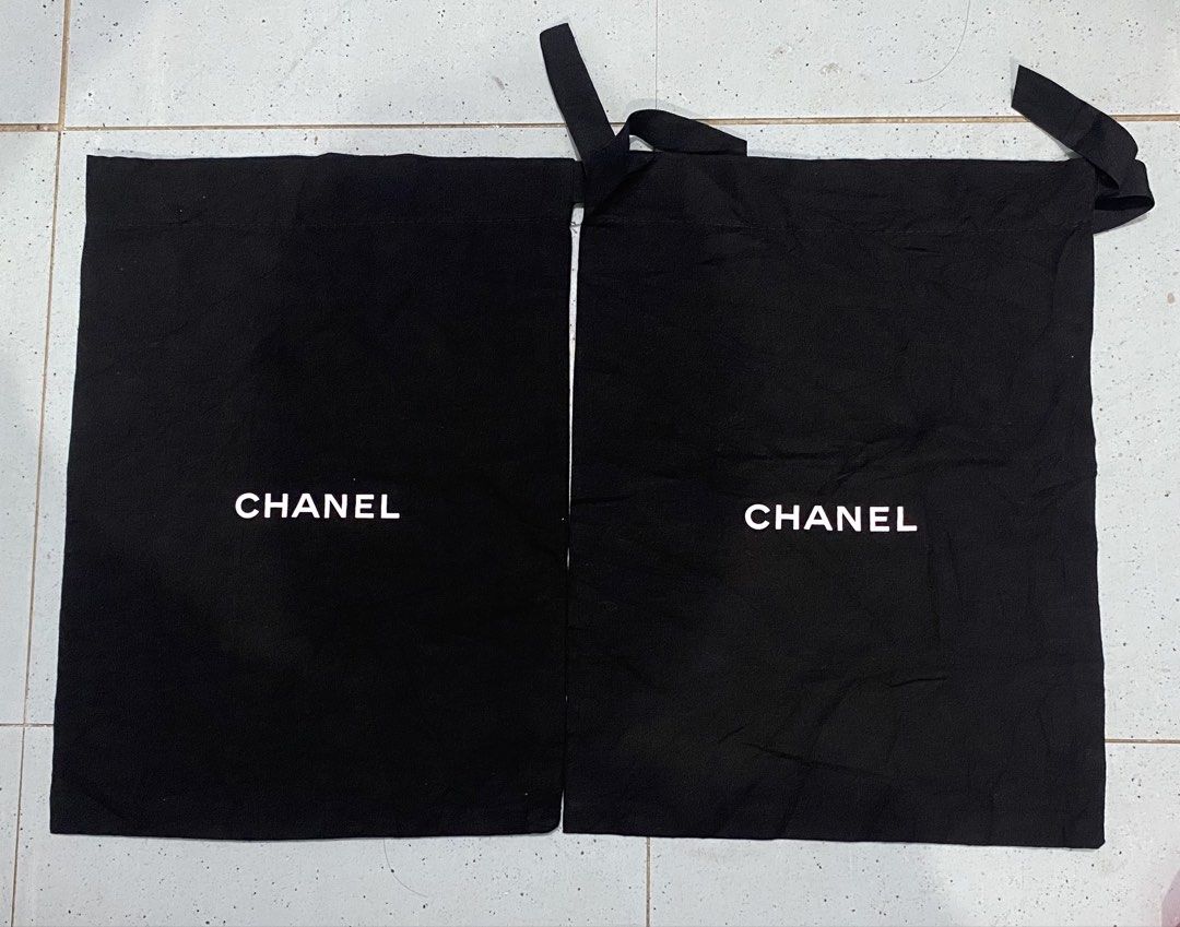 Chanel Black Dust Bags Pair (Category: Luxury Bags & Wallets) located in Davao. Submitted by dandeshop (Listing ID 1471089081, Image 1). Description: - Quantity: Set of 2 black Chanel dust bags - Material: Soft fabric with classic white Chanel lettering on the front - Closure: Convenient drawstring style with black ribbon ties.