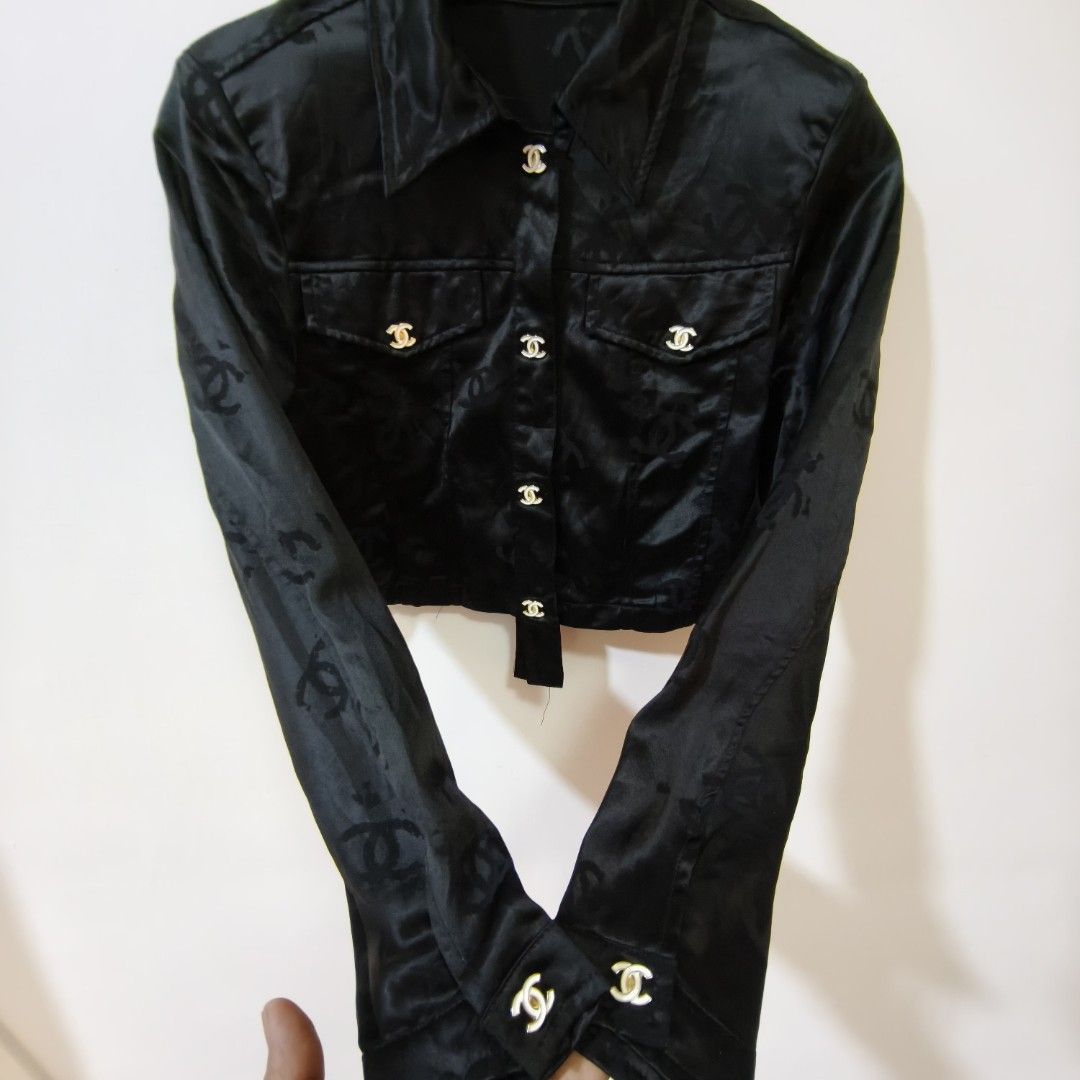 Chanel Black Monogram Silk Cropped Jacket (Category: Coats, Jackets and Outerwear) located in Quezon City. Submitted by inrelationthrift (Listing ID 1471028670, Image 2). Description: - Brand: Chanel - Material: Luxurious black silk with subtle woven CC monogram - Design: Cropped length, pointed lapel collar, button-up front - Pockets: Dual chest flap pockets - Hardware: Gold-toned buttons engraved with the iconic CC logo - Sleeves: Long sleeves 