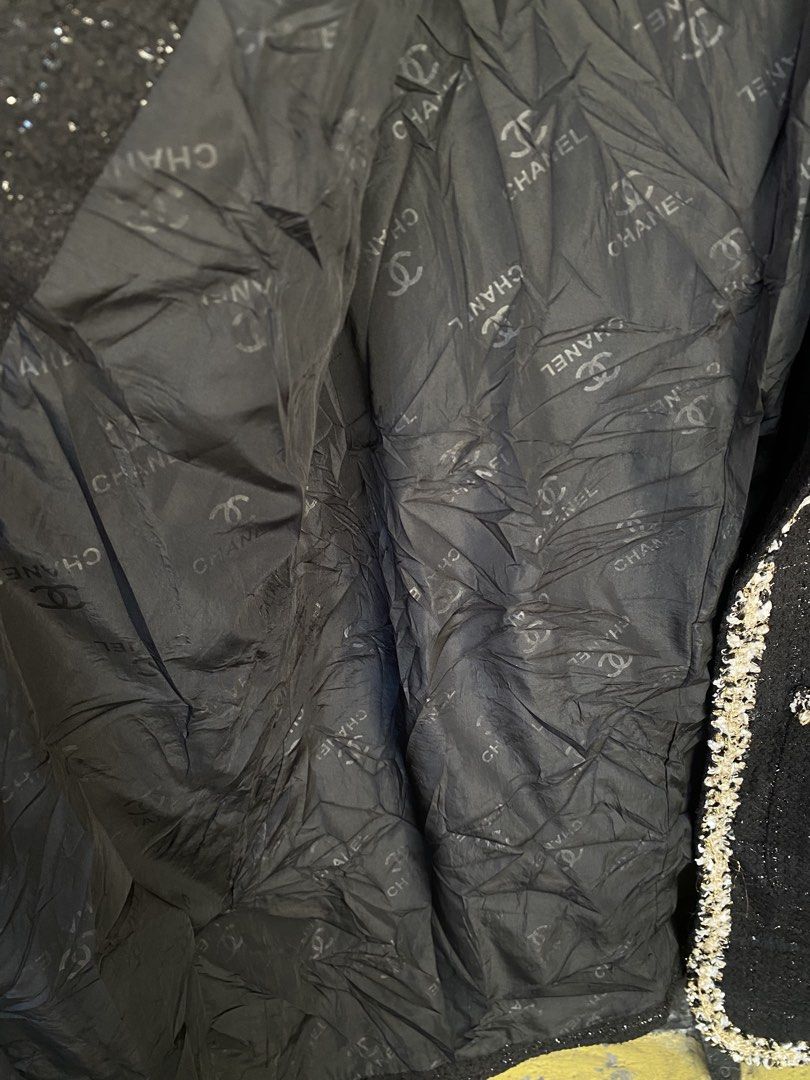 Chanel Black Tweed Long Jacket Size 44 (Category: Coats, Jackets and Outerwear) located in Tuguegarao City. Submitted by tumaliuanjohnpeter5-19041 (Listing ID 1470975366, Image 3). Description: - Brand: Chanel (Made in Italy) - Style: Black tweed long jacket / Open front design - Size: 44 - Material: 70% Wool, 30% Viscose (Outer); 100% Polyester with CC logo pattern (Lining) - Details: Textured metallic trim along edges, cuffs, and two front patc