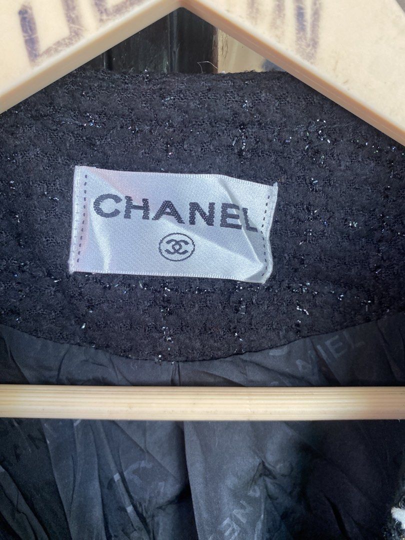 Chanel Black Tweed Long Jacket Size 44 (Category: Coats, Jackets and Outerwear) located in Tuguegarao City. Submitted by tumaliuanjohnpeter5-19041 (Listing ID 1470975366, Image 2). Description: - Brand: Chanel (Made in Italy) - Style: Black tweed long jacket / Open front design - Size: 44 - Material: 70% Wool, 30% Viscose (Outer); 100% Polyester with CC logo pattern (Lining) - Details: Textured metallic trim along edges, cuffs, and two front patc