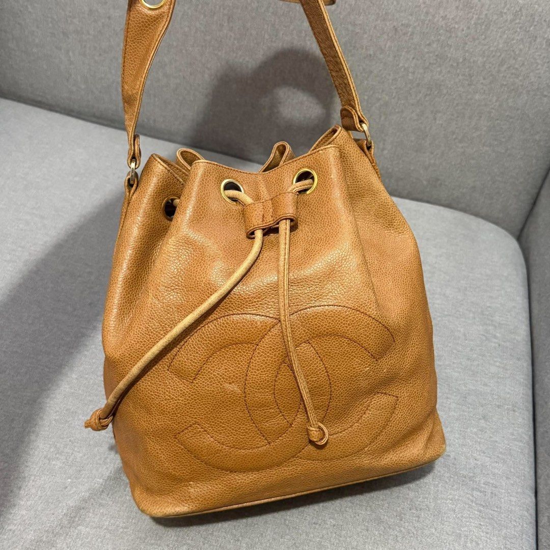 Chanel Caviar Leather Bucket Bag with Pouch (Category: Luxury Bags & Wallets) located in Madrid. Submitted by jhunaceee (Listing ID 1470938804, Image 3). Description: - Authentic Vintage Chanel bucket bag - Premium tan caviar leather with gold hardware - Iconic stitched interlocking CC logo on the front - Secure drawstring closure - Includes matching detachable zip pouch - Features stylish leather-and-chain strap - Perfect everyday luxury piece.