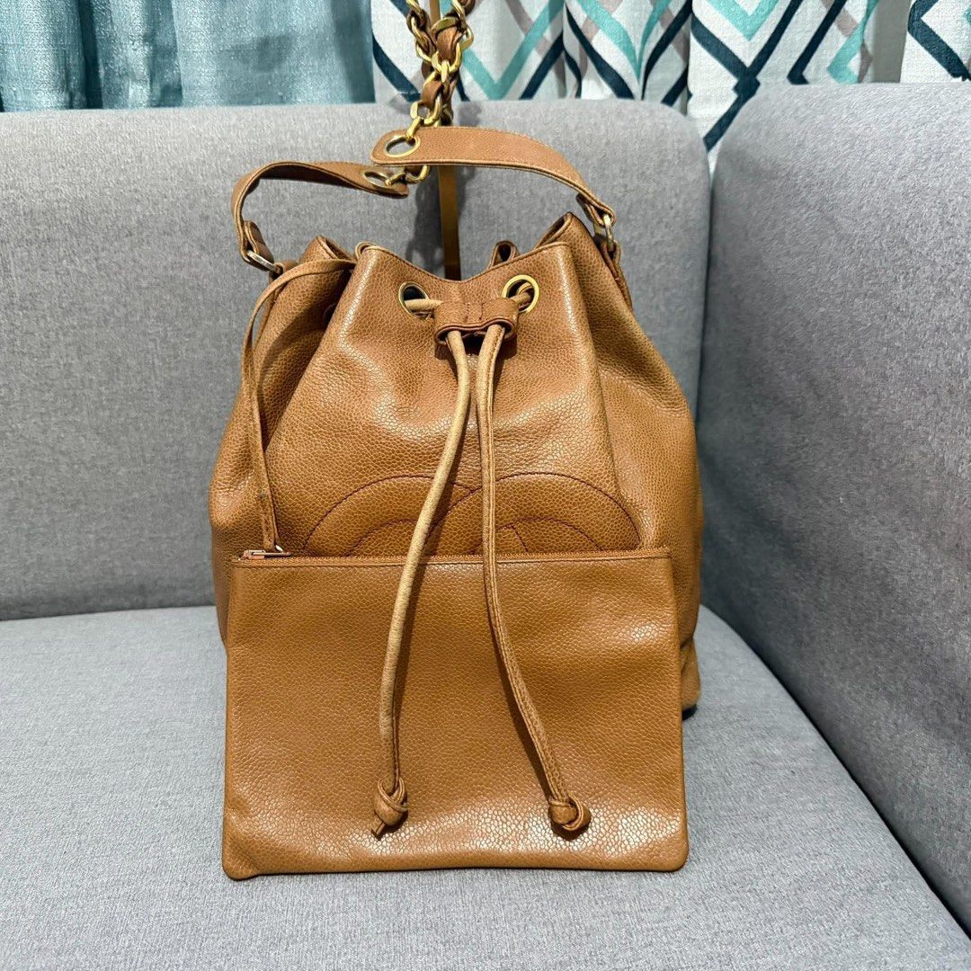 Chanel Caviar Leather Bucket Bag with Pouch (Category: Luxury Bags & Wallets) located in Madrid. Submitted by jhunaceee (Listing ID 1470938804, Image 2). Description: - Authentic Vintage Chanel bucket bag - Premium tan caviar leather with gold hardware - Iconic stitched interlocking CC logo on the front - Secure drawstring closure - Includes matching detachable zip pouch - Features stylish leather-and-chain strap - Perfect everyday luxury piece.