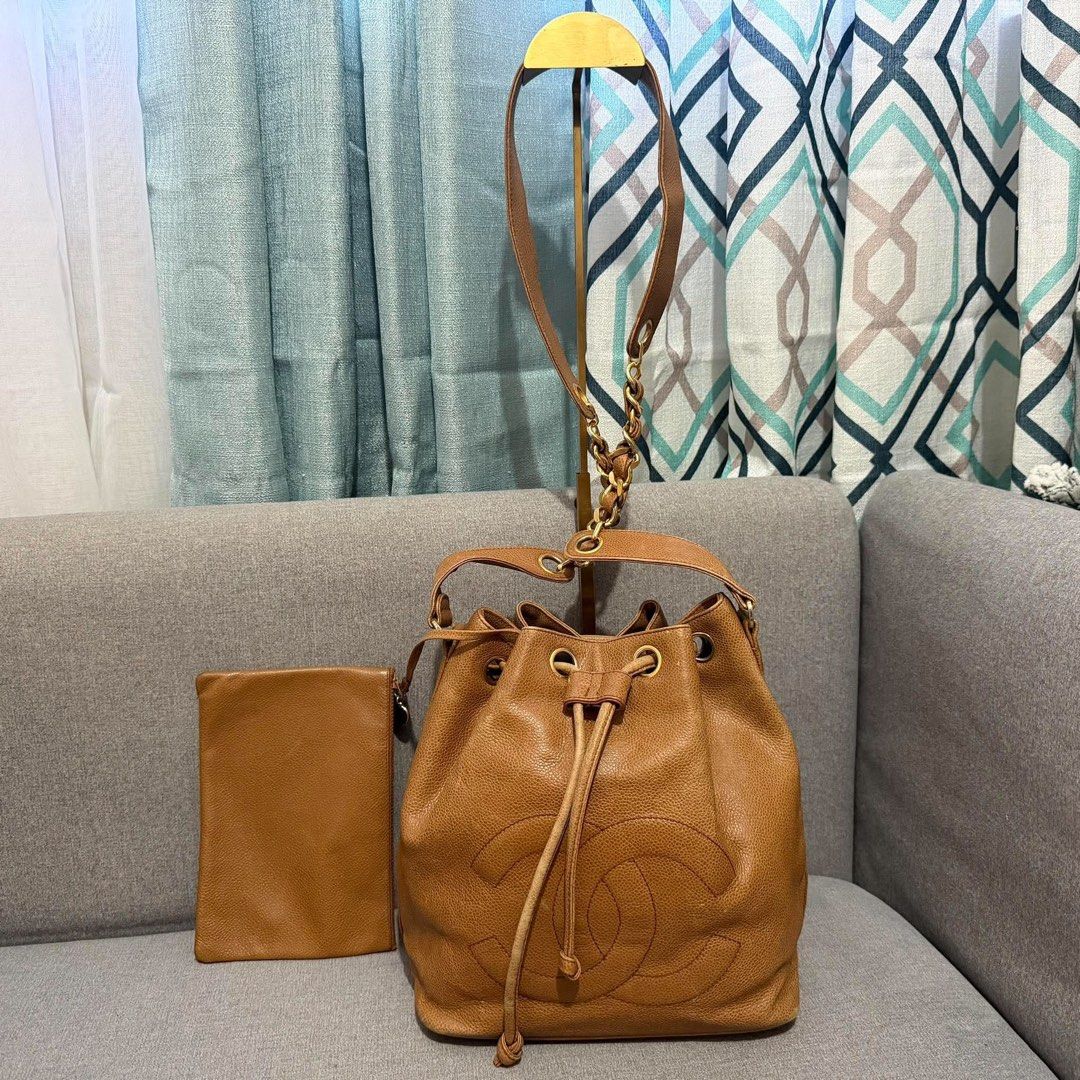 Chanel Caviar Leather Bucket Bag with Pouch (Category: Luxury Bags & Wallets) located in Madrid. Submitted by jhunaceee (Listing ID 1470938804, Image 1). Description: - Authentic Vintage Chanel bucket bag - Premium tan caviar leather with gold hardware - Iconic stitched interlocking CC logo on the front - Secure drawstring closure - Includes matching detachable zip pouch - Features stylish leather-and-chain strap - Perfect everyday luxury piece.