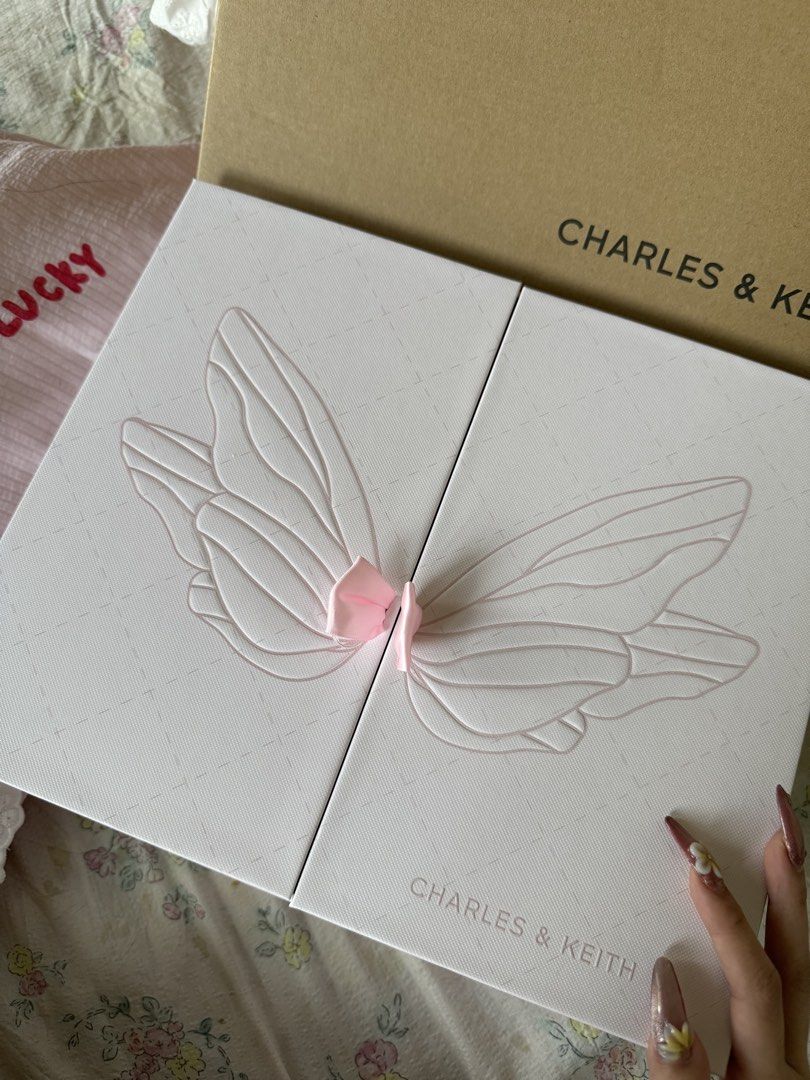 Charles & Keith Quilted Pink Handbag Gift Box Set (Category: Luxury Bags & Wallets) located in Manila. Submitted by xiaoyaoo444 (Listing ID 1471008274, Image 2). Description: - Brand: Charles & Keith - Item: Exclusive Pink Quilted Handbag Gift Box Set - Inclusions: Quilted top-handle bag, gold heart charm, and sparkly wing bag charm - Packaging: Comes in the original pink presentation box with outer sleeve - Condition: Unused with protective wrap
