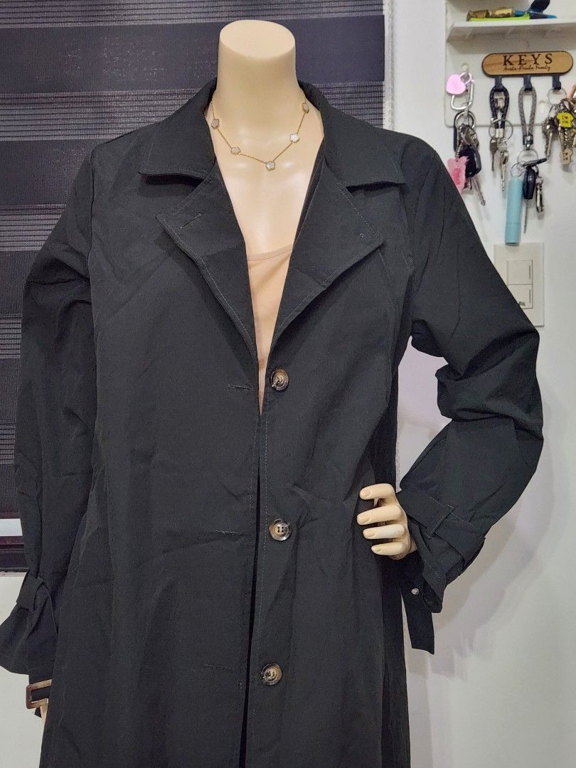 B-2 Classic Black Long Trench Coat (Category: Coats, Jackets and Outerwear) located in Tanza. Submitted by wearitagainph (Listing ID 1471012177, Image 2). Description: Sleek, chic, and versatile! Features a button-down front, classic notch lapel collar, and stylish gathered cuff details. * Bust: 43" * Length: 48" * Color: Black * Condition: Excellent DM to order or inquire!.