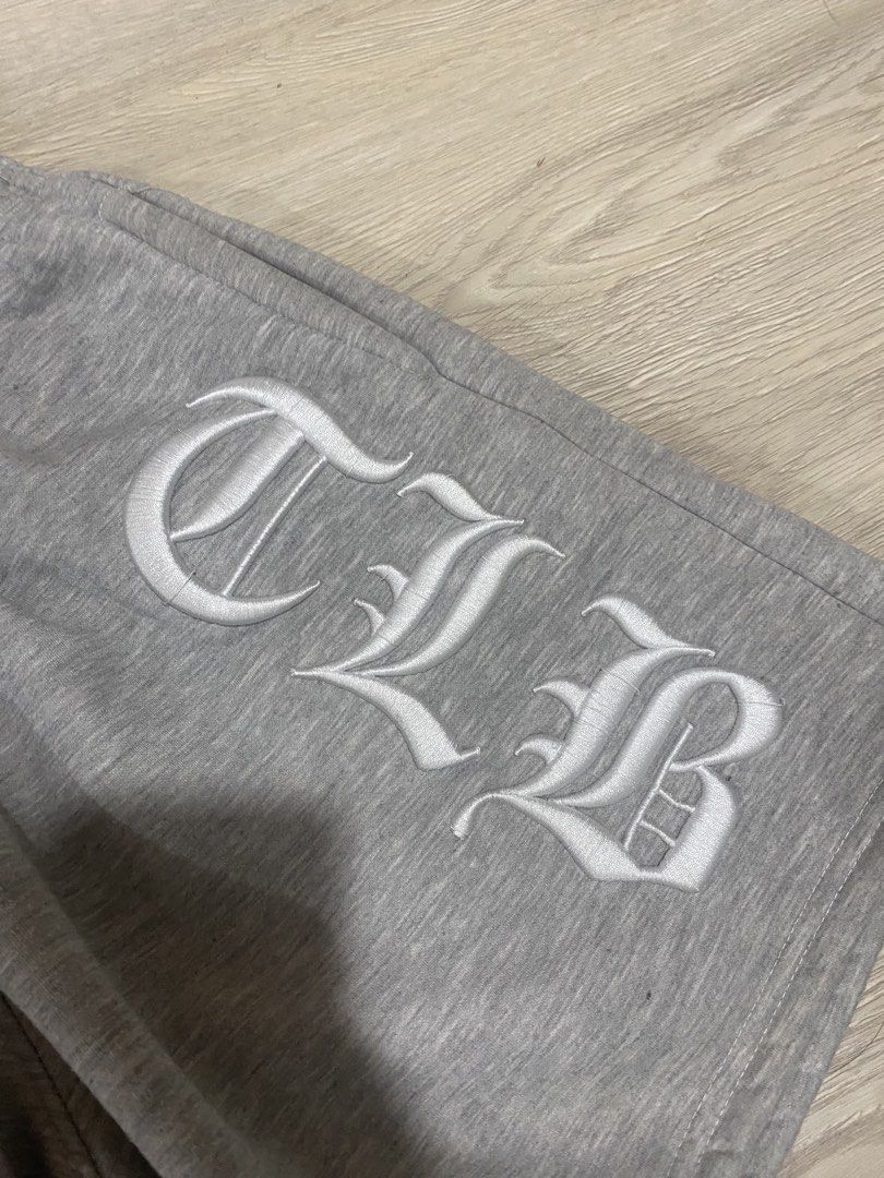 CLB Grey Sweatshorts Embroidered Gothic Font Size M (Category: Shorts) located in Caloocan City. Submitted by heatedcaps4425 (Listing ID 1471098881, Image 2). Description: - Size: Medium - Color: Grey - Material: Thick cotton with soft fuzzy fleece interior - Design: Embroidered CLB lettering in old English font on the side leg - Waistband: Elastic with internal drawstring - Condition: Clean, zero stains, and no loose threads.