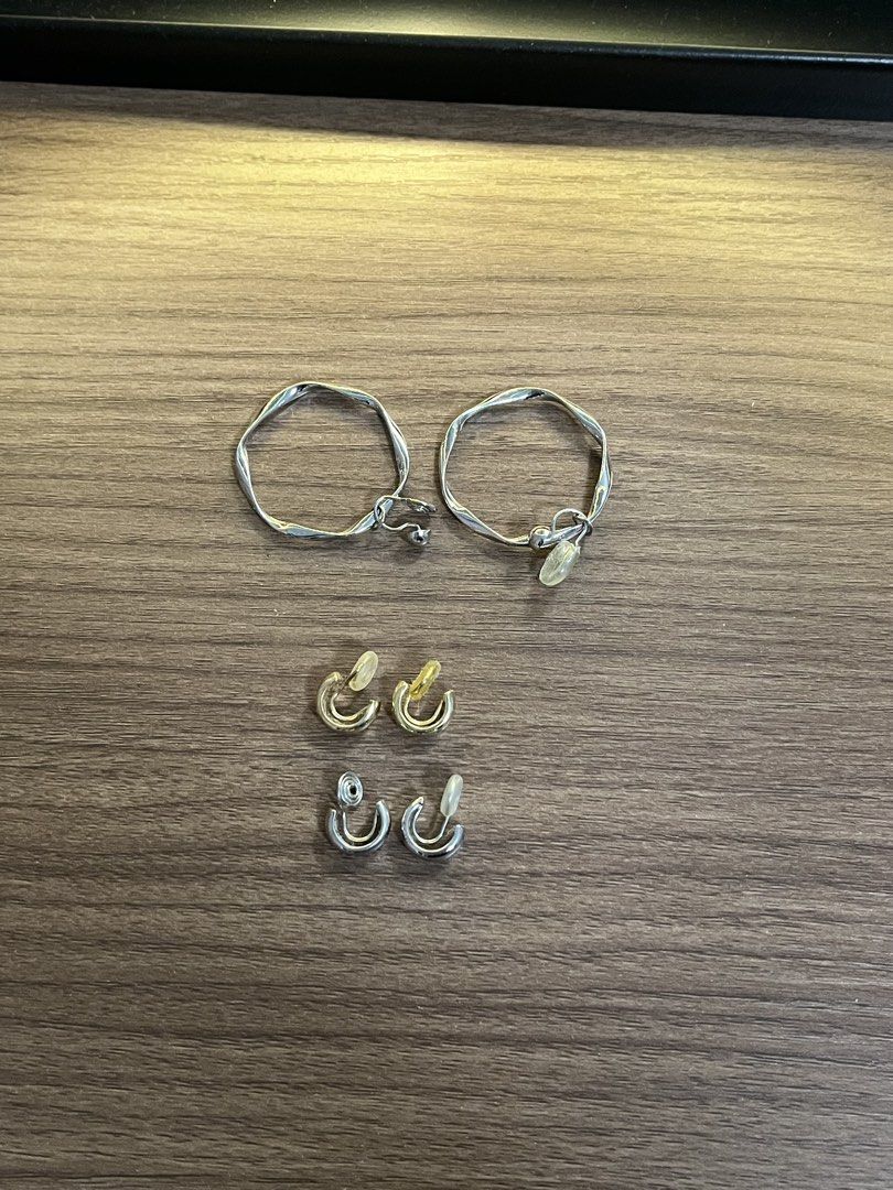Clip-on earrings bundle set silver and gold hoops (Category: Earrings) located in Manila. Submitted by clnxzs (Listing ID 1471077928, Image 1). Description: clip on earrings! only used once or twice since i got my ears pierced after :) og value: around 600 - Set of 3 pairs of clip-on earrings - Includes: 1 large wavy silver hoop, 1 small gold-toned hoop, and 1 small silver hoop - Designed with comfortable padded clip backs - Clean metal finish fo