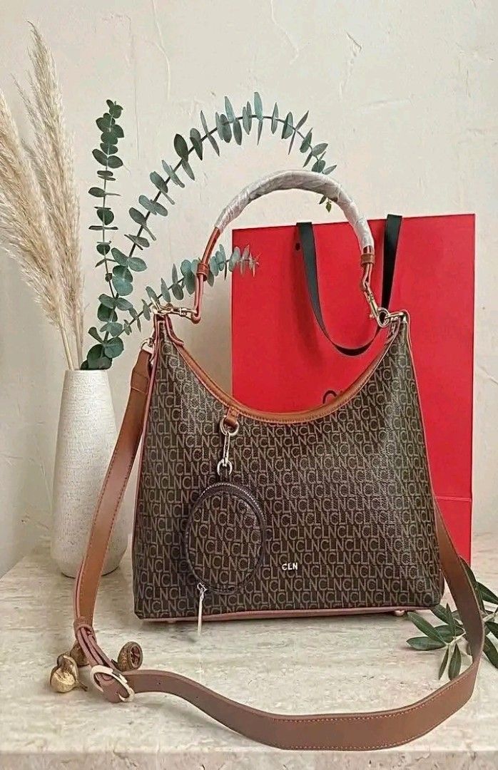 CLN Monogram Shoulder Bag with Coin Purse (Category: Luxury Bags & Wallets) located in Manila. Submitted by silvermoon_b802e0 (Listing ID 1470961779, Image 2). Description: - Brand: CLN - Design: Classic brown and cream monogram pattern - Includes: Matching mini round coin purse attached to the front ring - Straps: Brown adjustable shoulder strap and top handle (wrapped in protective plastic) - Freebie: Authentic red CLN paper shopping bag includ