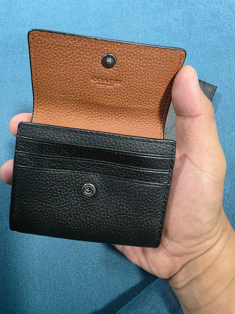 Coach Black Leather Wallet Card Holder Set (Category: Wallets & Card holders) located in Santa Maria. Submitted by purefalcon-f7cf (Listing ID 1471110098, Image 2). Description: - Authentic Coach black pebbled leather wallet and card holder set - Textured finish featuring debossed Coach New York logo - Snap button closure with contrast brown interior and card slots - Includes a matching removable black card case with ID window - Condition: Some i