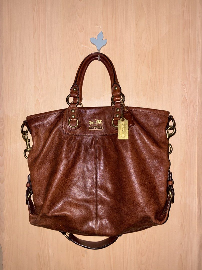 Coach Brown Leather Shoulder Bag Tote (Category: Luxury Bags & Wallets) located in Placer. Submitted by talaalond61563 (Listing ID 1471064890, Image 2). Description: - Authentic Coach Madison Julianne 2-way satchel and shoulder bag leather handbag in rich brown - Dual top handles and adjustable/removable shoulder strap - Classic brass hardware with iconic horse & carriage logo plate - Convenient exterior back zip pocket - Spacious interior with a
