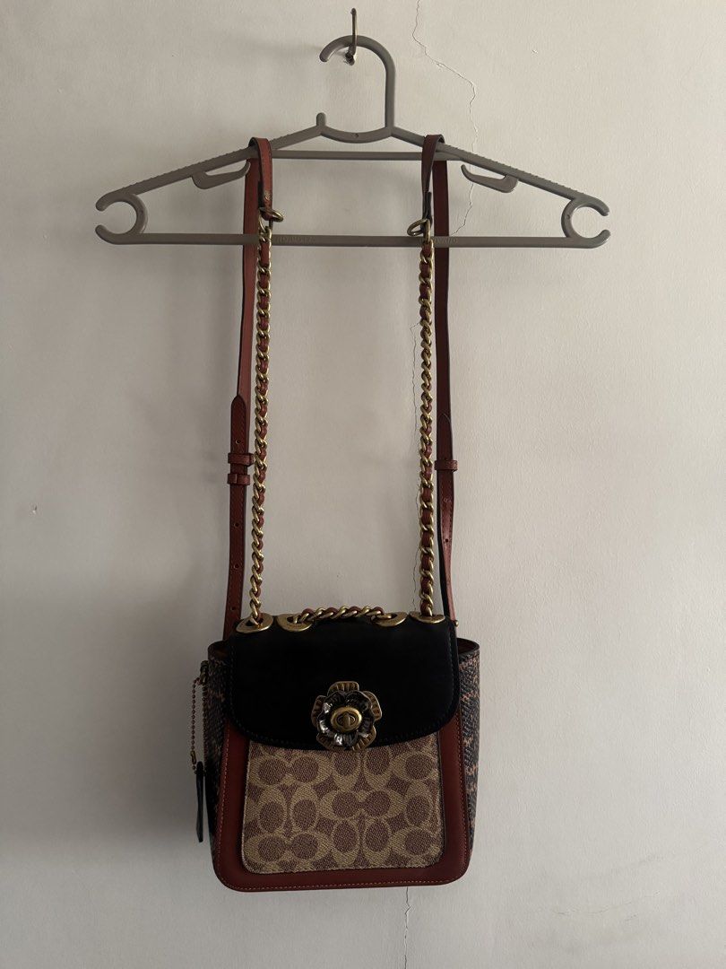 Coach Convertible backpack/Crossbody (Category: Luxury Bags & Wallets) located in Cagayan de Oro. Submitted by dan_kit (Listing ID 1470968931, Image 2). Description: - Brand: Coach Parker - Material: Signature canvas with black leather, red trim, and genuine snakeskin side panels - Hardware: Dark brass with a stylish floral turnlock closure - Strap: Versatile chain and leather strap for multiple ways of wearing - Features: Convenient exterior bac