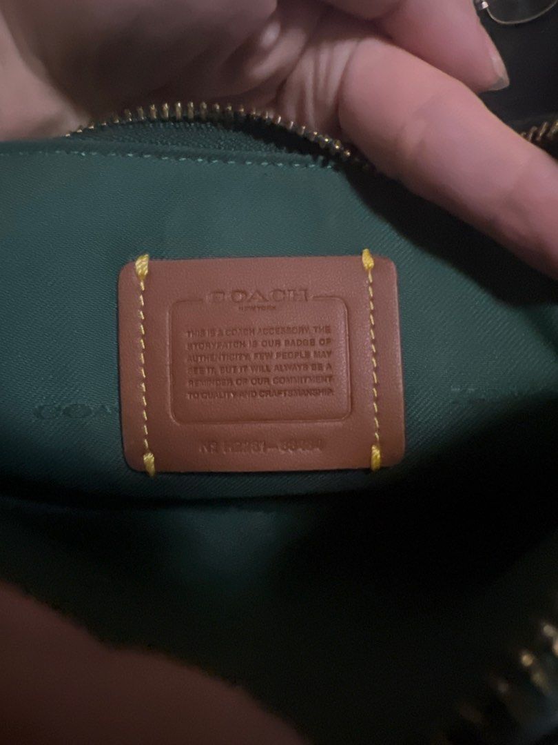 Coach Double Zip Bag Green Leather (Category: Luxury Bags & Wallets) located in Manila. Submitted by keliacrize70151 (Listing ID 1471025055, Image 3). Description: - Brand: Coach - Style: Double Zip Camera Bag - Material: Rich green pebbled leather - Hardware: Gold-tone with front horse and carriage logo - Compartments: Two main zippered compartments with internal storypatch details - Strap: Adjustable matching leather crossbody strap with dog le