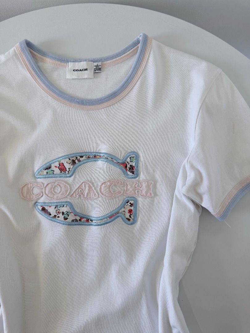 Coach Floral Patch Logo Ringer y2k shirt (Category: Shirts) located in Cabanatuan. Submitted by argarments.ph (Listing ID 1470949634, Image 2). Description: Tagged: Large on tag Width 18.5" | Length 24.5" Condition: Good condition Issue(s): Dirt stain. see photos.