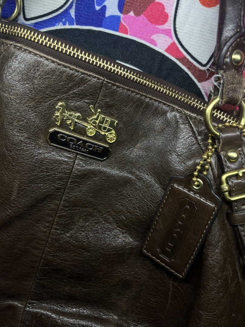Coach Leather Handbag Brown 15955 (Category: Luxury Bags & Wallets) located in Impasugong. Submitted by luisterpicks (Listing ID 1471060295, Image 3). Description: - Brand: Coach - Color: Dark brown leather with vibrant turquoise fabric lining - Hardware: Brass hardware with matching hangtag - Closure & Handles: Top zip closure, dual top handles, and a detachable shoulder strap - Interior: Includes zip and slip pockets for easy organization - Det