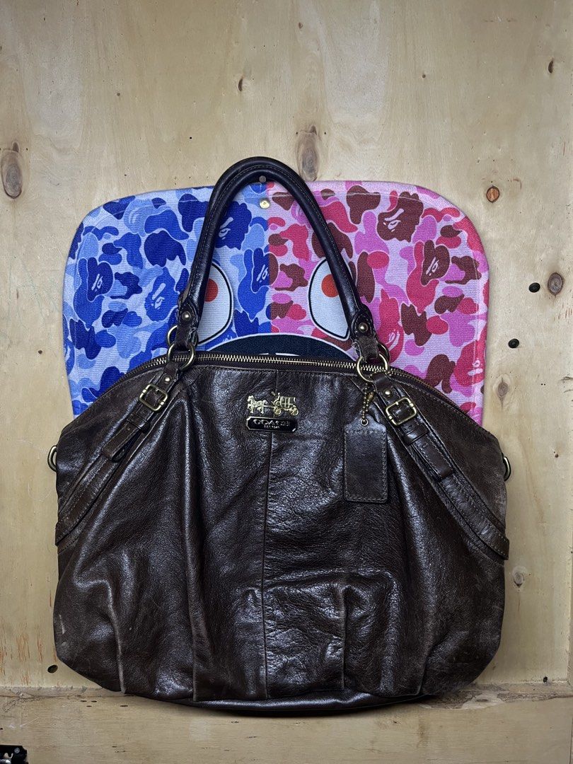 Coach Leather Handbag Brown 15955 (Category: Luxury Bags & Wallets) located in Impasugong. Submitted by luisterpicks (Listing ID 1471060295, Image 1). Description: - Brand: Coach - Color: Dark brown leather with vibrant turquoise fabric lining - Hardware: Brass hardware with matching hangtag - Closure & Handles: Top zip closure, dual top handles, and a detachable shoulder strap - Interior: Includes zip and slip pockets for easy organization - Det