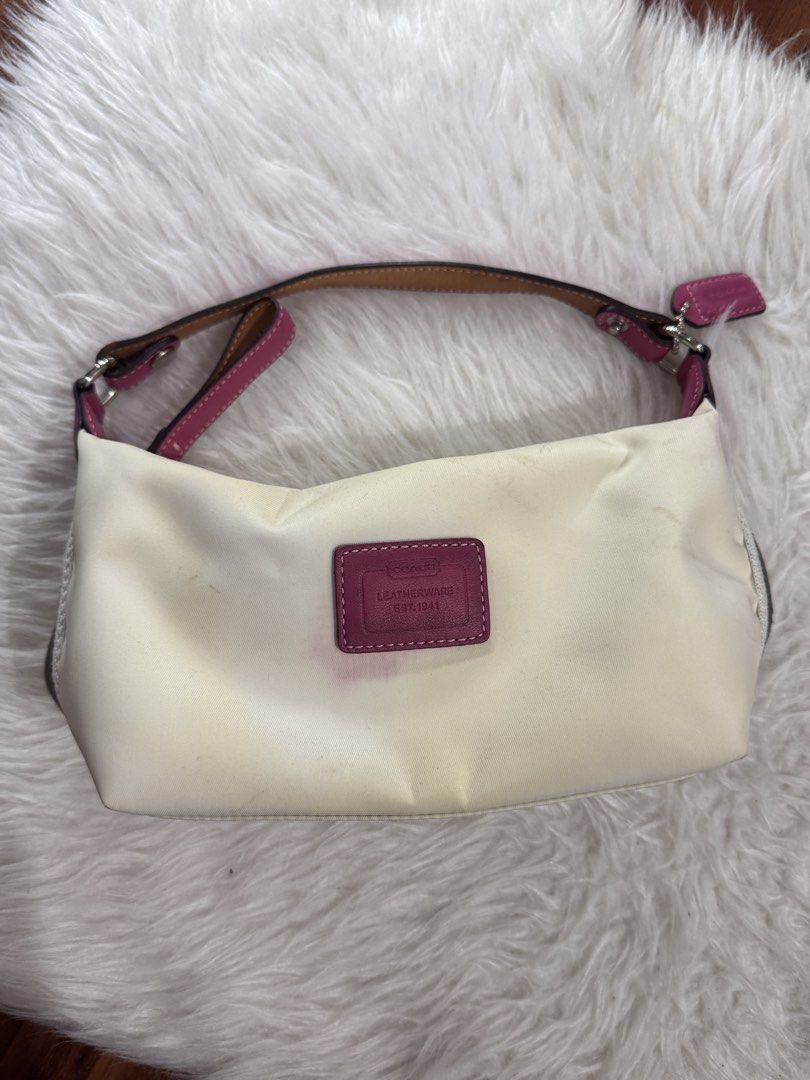 Coach Leatherware Mini Shoulder Bag White Pink (Category: Luxury Bags & Wallets) located in Bocaue. Submitted by nhaomiee (Listing ID 1471023094, Image 1). Description: - Authentic Coach mini shoulder bag - White fabric body with vibrant pink leather trim and straps - Features a small Coach Leatherware stamped patch in magenta on the front - Includes original matching pink hangtag - Secure zipper closure along the top - Condition note: Shows visi