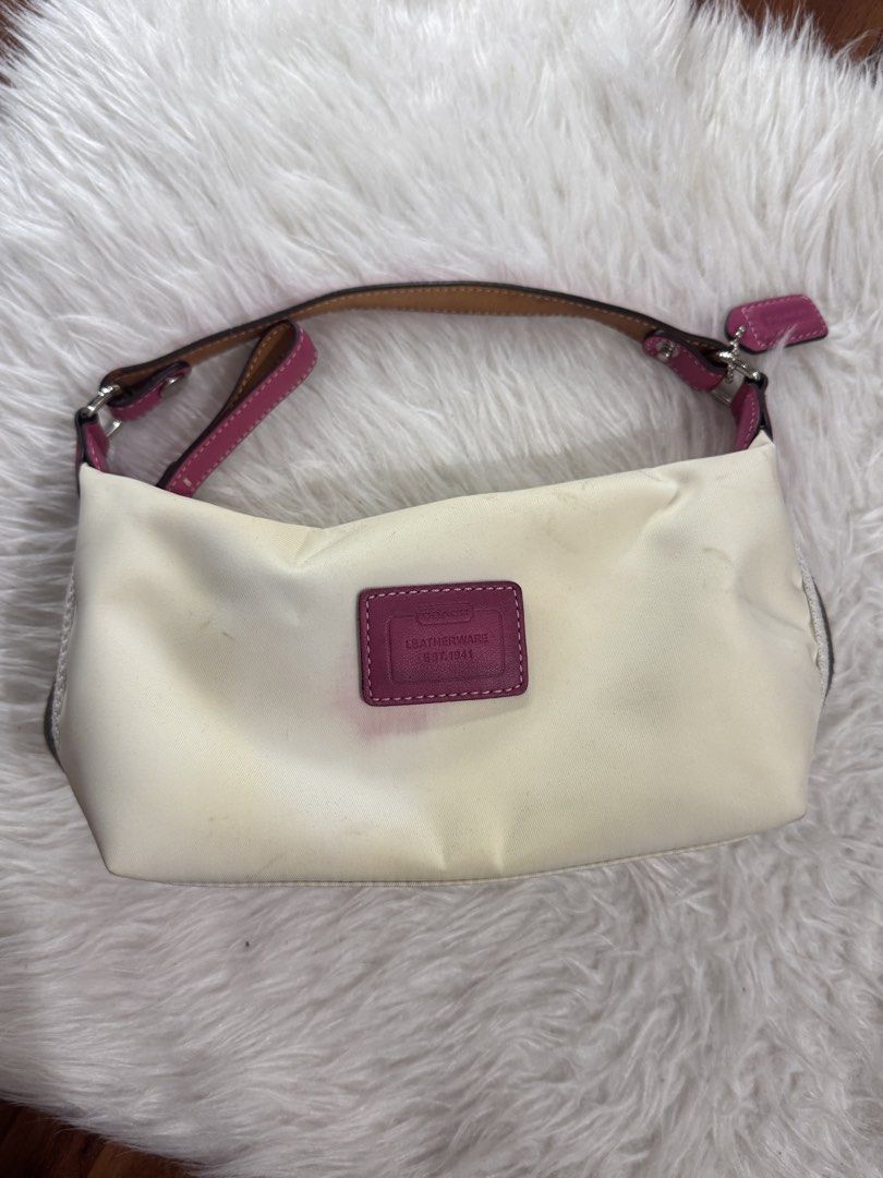 Coach Leatherware Mini Shoulder Bag White Pink (Category: Luxury Bags & Wallets) located in Bocaue. Submitted by nhaomiee (Listing ID 1471023094, Image 2). Description: - Authentic Coach mini shoulder bag - White fabric body with vibrant pink leather trim and straps - Features a small Coach Leatherware stamped patch in magenta on the front - Includes original matching pink hangtag - Secure zipper closure along the top - Condition note: Shows visi