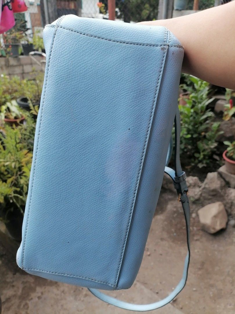 Coach Light Blue Leather Handbag with Crossbody Strap (Category: Luxury Bags & Wallets) located in Digos. Submitted by crodualady82694 (Listing ID 1470972881, Image 3). Description: - Brand: Coach - Color: Light Blue - Material: Genuine Leather - Hardware: Gold-tone - Features: Top handles, detachable crossbody strap, front logo plate - Interior: Zip middle compartment with open side pockets - Condition: Shows some scuffs and marks on the exterio