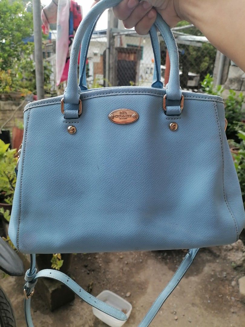 Coach Light Blue Leather Handbag with Crossbody Strap (Category: Luxury Bags & Wallets) located in Digos. Submitted by crodualady82694 (Listing ID 1470972881, Image 1). Description: - Brand: Coach - Color: Light Blue - Material: Genuine Leather - Hardware: Gold-tone - Features: Top handles, detachable crossbody strap, front logo plate - Interior: Zip middle compartment with open side pockets - Condition: Shows some scuffs and marks on the exterio