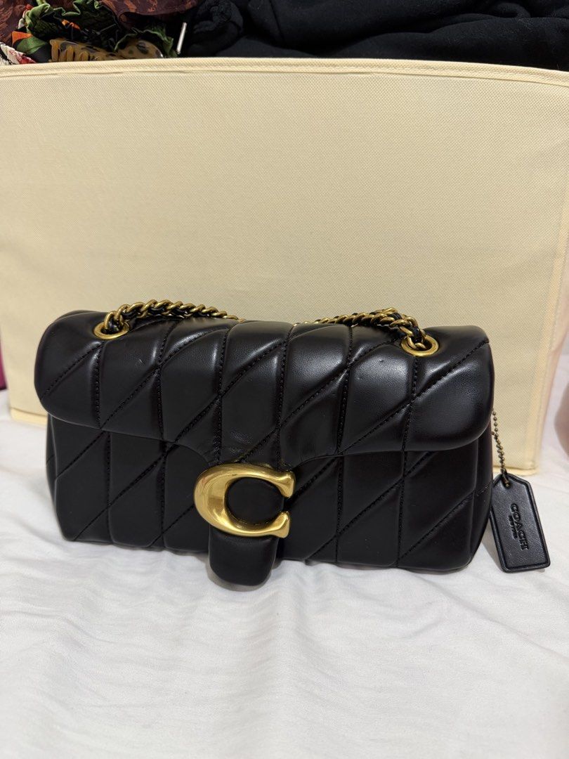 Coach Quilted Pillow Tabby Shoulder Bag Black (Category: Luxury Bags & Wallets) located in Marilao. Submitted by anp129 (Listing ID 1471036138, Image 2). Description: - Authentic Coach black quilted leather shoulder bag - Features iconic oversized C hardware in antique brass - Versatile sliding chain strap for single or double carry - Trendy pillow silhouette with chic diagonal stitching - Secure flap closure with a clean interior compartment - I