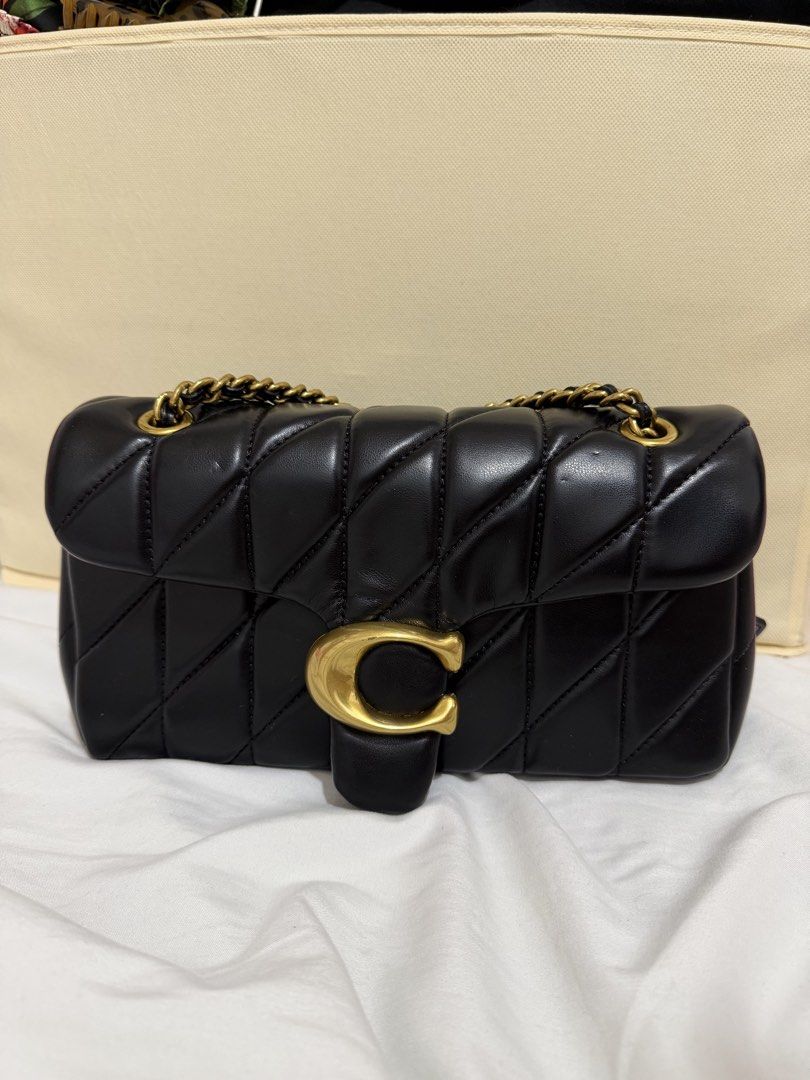 Coach Quilted Pillow Tabby Shoulder Bag Black (Category: Luxury Bags & Wallets) located in Marilao. Submitted by anp129 (Listing ID 1471036138, Image 1). Description: - Authentic Coach black quilted leather shoulder bag - Features iconic oversized C hardware in antique brass - Versatile sliding chain strap for single or double carry - Trendy pillow silhouette with chic diagonal stitching - Secure flap closure with a clean interior compartment - I