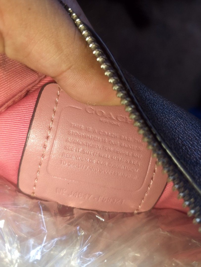 Coach Signature Canvas Mini Handbag (Category: Luxury Bags & Wallets) located in Caloocan City. Submitted by ndkph (Listing ID 1470971761, Image 3). Description: - Authentic Coach monogram canvas bag in classic dark brown - Beautiful pink leather piping and matching strap - Sleek silver hardware with signature Coach New York zipper pull - Clean pink fabric lining on the inside - Features authentic story patch and creed number: J4047-F58321 - Guar