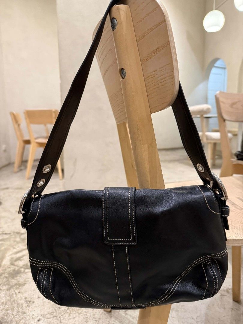 Coach Soho Black Leather Shoulder Double Pocket (Category: Luxury Bags & Wallets) located in Pasig City. Submitted by loveforlux_2025 (Listing ID 1471073500, Image 3). Description: - Authentic Coach black leather shoulder bag - Chic contrast stitching with polished silver hardware - Front buckle closure with a secure snap button - Clean fabric interior featuring dark side slip pockets - Single adjustable strap accented with metal grommets - Signa