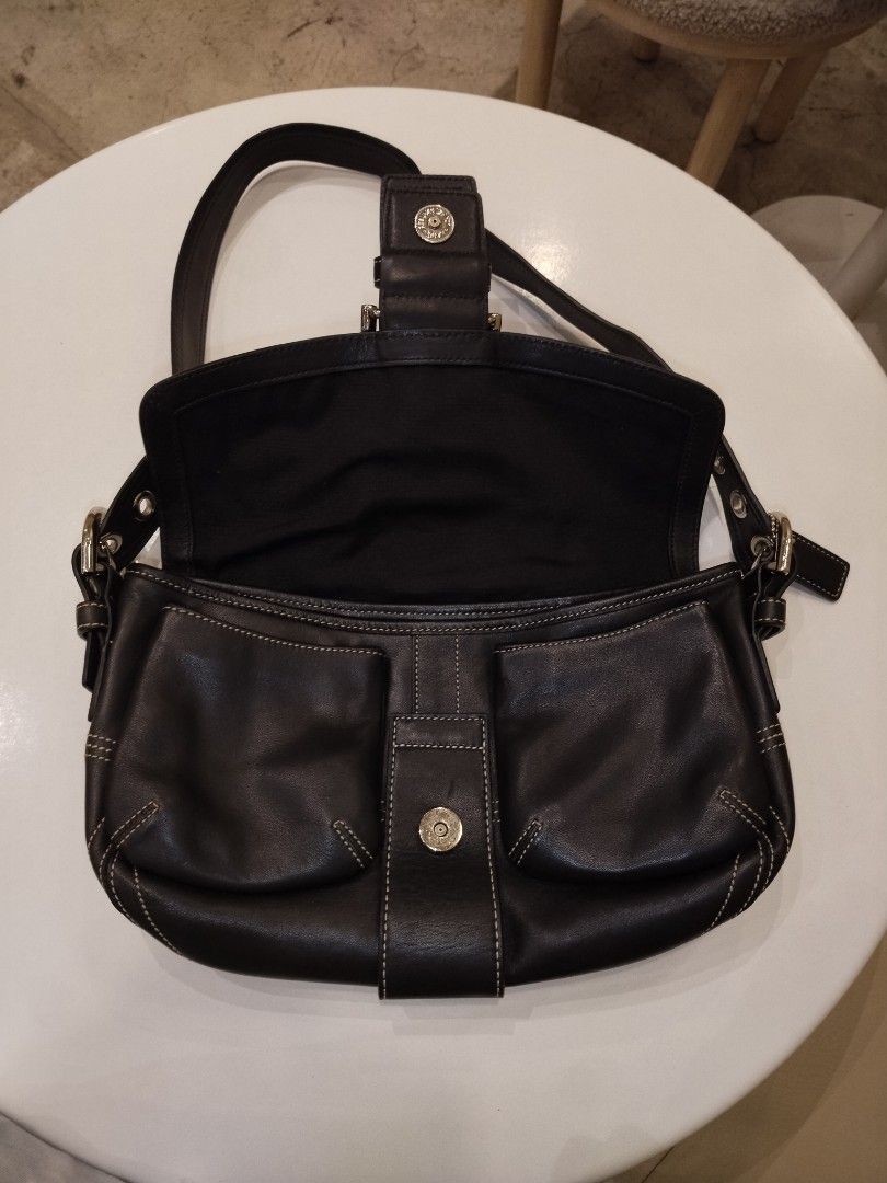 Coach Soho Black Leather Shoulder Double Pocket (Category: Luxury Bags & Wallets) located in Pasig City. Submitted by loveforlux_2025 (Listing ID 1471073500, Image 2). Description: - Authentic Coach black leather shoulder bag - Chic contrast stitching with polished silver hardware - Front buckle closure with a secure snap button - Clean fabric interior featuring dark side slip pockets - Single adjustable strap accented with metal grommets - Signa