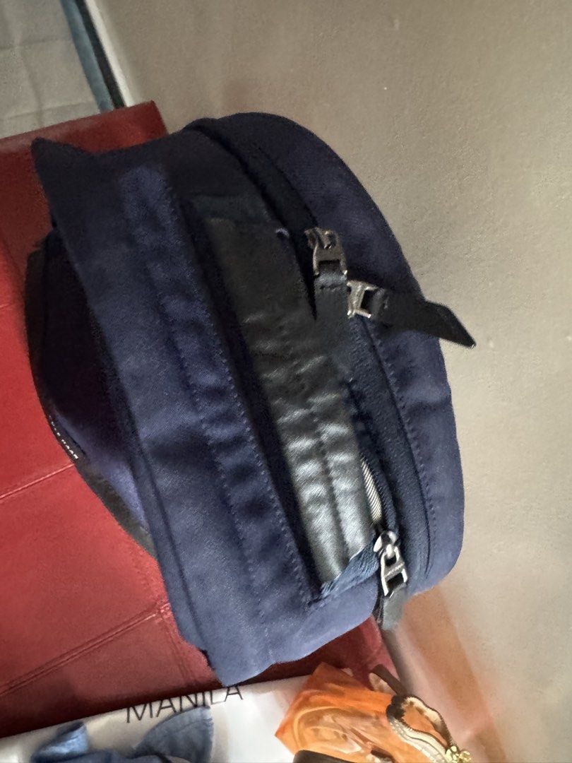 Cole Haan GrandSeries Navy Blue Backpack (Category: Backpacks) located in Taguig. Submitted by almero22 (Listing ID 1470989310, Image 2). Description: - Brand: Cole Haan - Color: Navy blue with black leather accents - Material: Sturdy canvas exterior with durable zippers - Interior: Grey lining with organizing slip pockets - Features: Secure zippered compartments and a sturdy top handle - Best for: Daily commute, work, school, or travel - Conditi