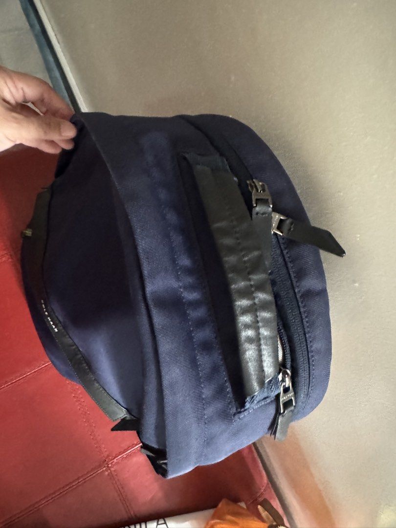 Cole Haan GrandSeries Navy Blue Backpack (Category: Backpacks) located in Taguig. Submitted by almero22 (Listing ID 1470989310, Image 3). Description: - Brand: Cole Haan - Color: Navy blue with black leather accents - Material: Sturdy canvas exterior with durable zippers - Interior: Grey lining with organizing slip pockets - Features: Secure zippered compartments and a sturdy top handle - Best for: Daily commute, work, school, or travel - Conditi