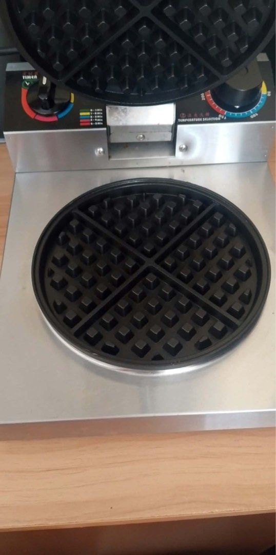 Commercial Round Waffle Maker Stainless Steel (Category: Cookware & Accessories) located in Iloilo. Submitted by clariceanyanicole (Listing ID 1471033604, Image 2). Description: - Heavy-duty commercial waffle maker - Durable stainless steel body with clean, non-stick cooking plates - Bakes 4 separate round waffle sections at once - Built-in timer dial and temperature control knob - Spring-wrapped cool-touch handle for safe baking - Fully function