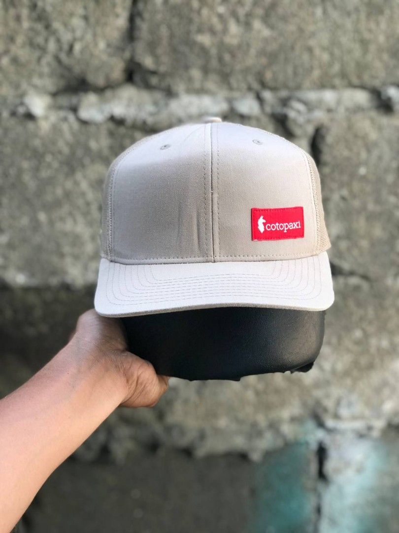 Cotopaxi Yupoong The Classics Snapback Hat Beige (Category: Caps & Hats) located in Manila. Submitted by jowiegarci63146 (Listing ID 1471073994, Image 1). Description: Cotopaxi trucker hat in beige. Yupoong The Classics tag inside. Snapback closure at the back, fully adjustable. Mesh back panels for ventilation. Red logo patch on the front crown. Cotton, polyester, and nylon blend material. Made in Vietnam..