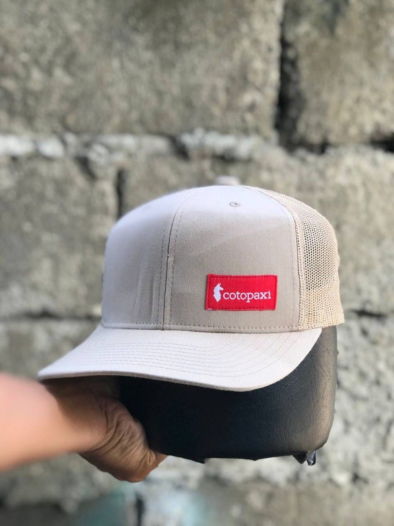 Cotopaxi Yupoong The Classics Snapback Hat Beige (Category: Caps & Hats) located in Manila. Submitted by jowiegarci63146 (Listing ID 1471073994, Image 2). Description: Cotopaxi trucker hat in beige. Yupoong The Classics tag inside. Snapback closure at the back, fully adjustable. Mesh back panels for ventilation. Red logo patch on the front crown. Cotton, polyester, and nylon blend material. Made in Vietnam..