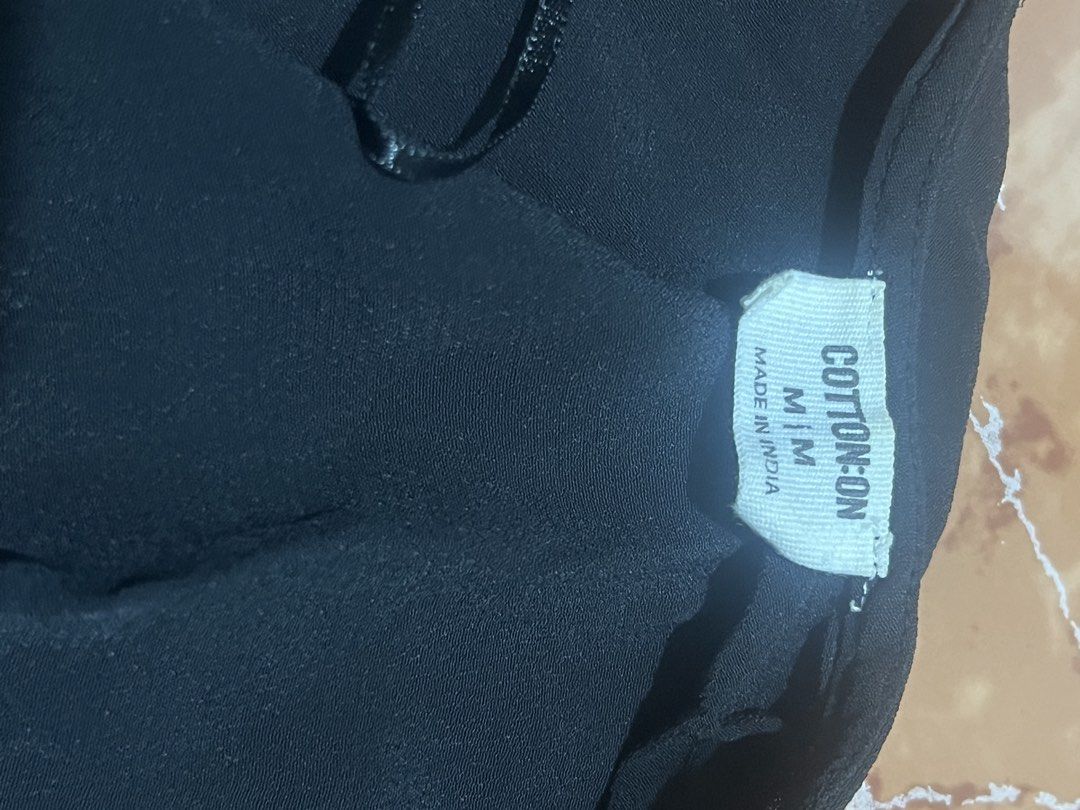 Cotton On Black Open Front Cardigan Size M (Category: Coats, Jackets and Outerwear) located in Muntinlupa City. Submitted by saiki__ (Listing ID 1470934560, Image 3). Description: - Brand: Cotton On - Size: Medium (tag attached) - Color: Classic Black - Design: Open front with stylish puff shoulders and short sleeves - Fabric: Lightweight and comfortable, made in India - Condition: Excellent, easy to throw on over casual or dressy outfits.