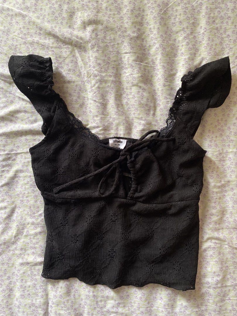 Cotton On Black Ruffle Strap Crop Top XS (Category: Sleeveless) located in Quezon City. Submitted by damclothings.ph (Listing ID 1470951286, Image 1). Description: - Brand: Cotton On - Size: XS - Color: Black with subtle diamond texture - Design: Scoop neckline with lace trim, short ruffle sleeves, and chest tie-up detail - Hem: Trendy lettuce hem with a cropped length - Material: Lightweight, comfortable fabric - Condition: Excellent/Like new - 