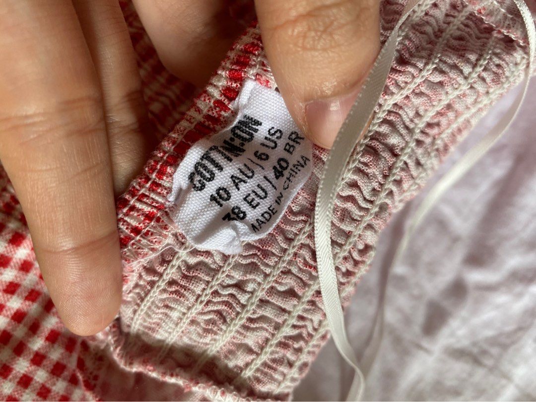 Cotton On Red Gingham Check Halter Top Size 10 (Category: Sleeveless) located in Quezon City. Submitted by damclothings.ph (Listing ID 1470951116, Image 3). Description: - Brand: Cotton On - Size: 10 AU / 6 US - Color/Pattern: Red and white gingham - Style: Halter neck with tie straps, smocked back panel, cropped fit - Material: Lightweight fabric - Condition: Great for warm weather and casual outings.