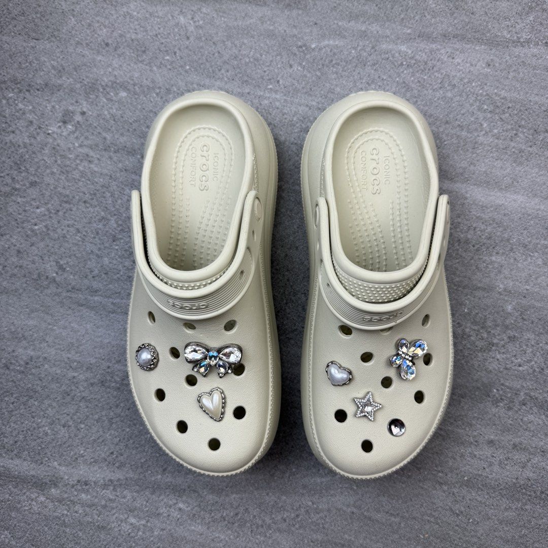 Crocs Crush Clogs Bone Cream Size M5W7 with Charms (Category: Slippers and slides) located in Manolo Fortich. Submitted by thrift_by_biji (Listing ID 1471089278, Image 2). Description: Bone cream Crocs Crush clogs, platform style. Size M5W7, fits women's size 7. Decorated with sparkly rhinestone Jibbitz charms including a butterfly, bow, star, and hearts. Thick sole design, lightweight foam. Clean soles, minimal wear shown in pictures. Great ever
