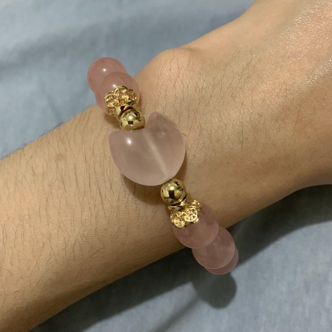 High Quality Crystal Moon Rose Quartz Charm Bracelet (Category: Bracelets) located in Quezon City. Submitted by itscxyy (Listing ID 1468066262, Image 3). Description: - Material: Genuine natural rose quartz gemstone beads from Madagascar with gold-toned metal spacers - Focal Piece: Beautiful large carved crescent moon bead in the center - Comfortably fits most wrist sizes - Appearance: Pale pink stones with a lovely light-catching shimmer.