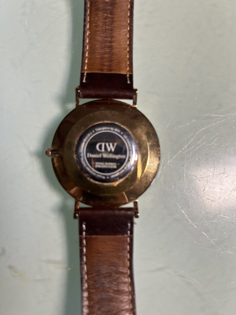 Daniel Wellington Classic Watch Dark Brown Leather Strap (Category: Men's Watches) located in Cavite. Submitted by mamamia73 (Listing ID 1471082262, Image 3). Description: - Brand: Daniel Wellington - Case Size: 40 (measured) - Color: Rose gold case with a clean white dial - Strap: Dark brown genuine leather (Note: shows heavy wear and creasing near the top buckle area) - Design: Classic minimalist face with simple line markers - Details: Brand t